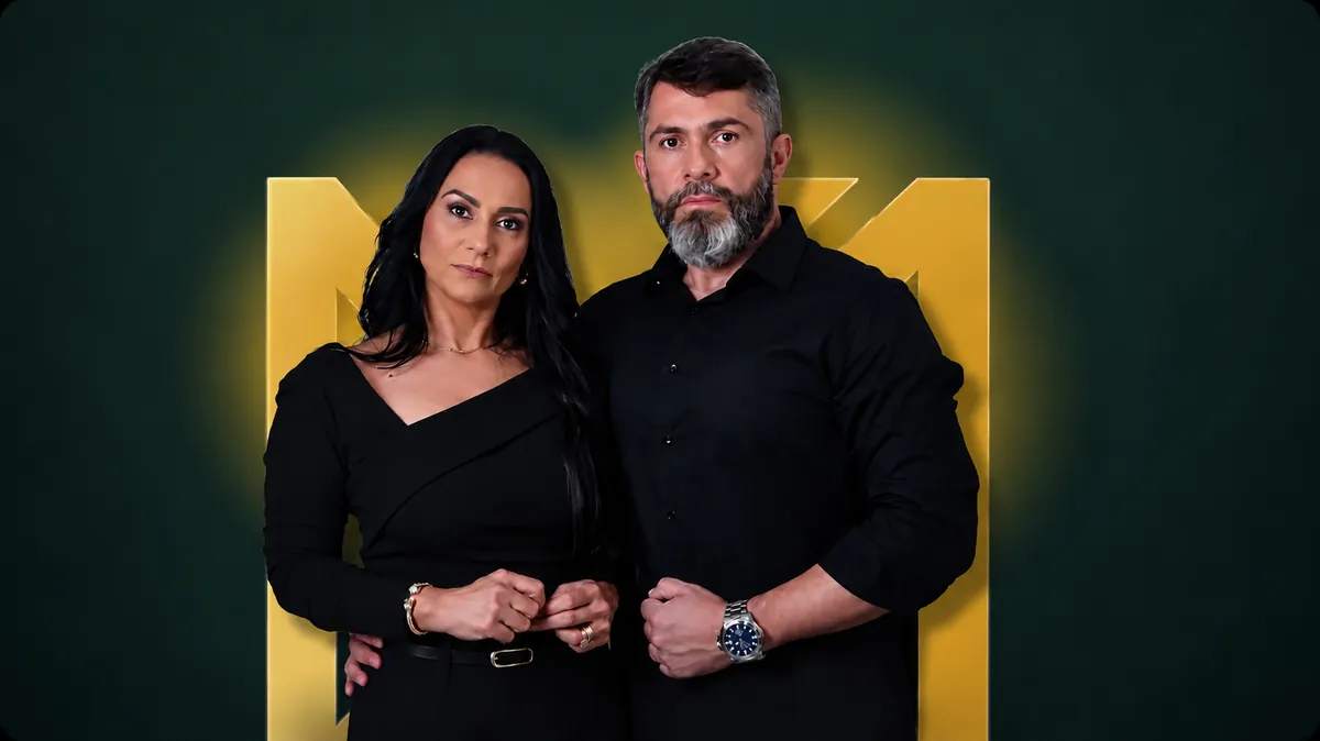 Fundadores da M&A Contabilidade Consultiva diante do símbolo dourado da marca